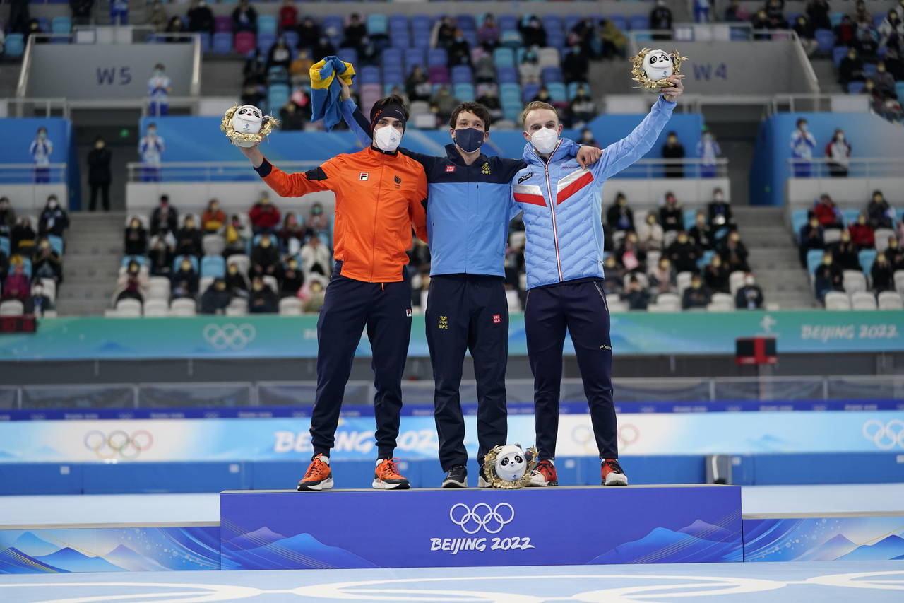 Gold medalist Nils van der Poel of Sweden, center, celebrates with silver medalist Patrick Roest of...