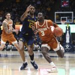 
              Texas guard Courtney Ramey (3) is defended by West Virginia guard Taz Sherman (12) during the first half of an NCAA college basketball game in Morgantown, W.Va., Saturday, Feb. 26, 2022. (AP Photo/Kathleen Batten)
            