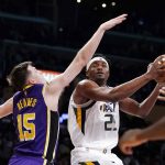 
              Utah Jazz forward Danuel House Jr., right, shoots as Los Angeles Lakers guard Austin Reaves defends during the first half of an NBA basketball game Wednesday, Feb. 16, 2022, in Los Angeles. (AP Photo/Mark J. Terrill)
            