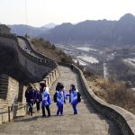 
              A group of journalists with volunteers covering the 2022 Winter Olympics, visit the Juyongguan section of the Great Wall the Wednesday, Feb. 9, 2022, on the outskirts of Beijing. (AP Photo/Chisato Tanaka)
            