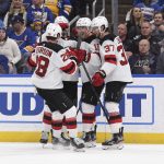 
              New Jersey Devils left wing Jimmy Vesey (16), center, is congratulated after scoring a goal against the St. Louis Blues during the third period of an NHL hockey game Thursday, Feb. 10, 2022, in St. Louis. (AP Photo/Joe Puetz)
            