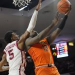 
              Oklahoma State guard Isaac Likekele (13) shoots in front of Oklahoma guard Marvin Johnson (5) in the first 106half of an NCAA college basketball game Saturday, Feb. 26, 2022, in Norman, Okla. (AP Photo/Sue Ogrocki)
            