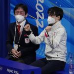
              Yuma Kagiyama, right, of Japan, reacts following the men's short program figure skating competition at the 2022 Winter Olympics, Tuesday, Feb. 8, 2022, in Beijing. (AP Photo/Natacha Pisarenko)
            