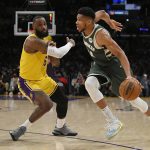 
              Los Angeles Lakers forward LeBron James (6) guards Milwaukee Bucks forward Giannis Antetokounmpo (34) in the first half in an NBA basketball game, Tuesday, Feb. 8, 2022, in Los Angeles. (AP Photo/John McCoy)
            