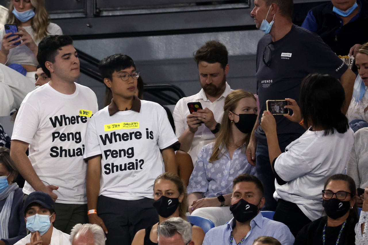 Supporters of Chinese tennis player Peng Shuai wear T-shirts as they pose for a photo during the wo...