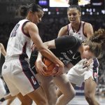 
              Connecticut's Evina Westbrook, left, and Connecticut's Olivia Nelson-Ododa, back, pressure Providence's Lauren Sampson, center, in the first half of an NCAA college basketball game, Sunday, Feb. 27, 2022, in Storrs, Conn. (AP Photo/Jessica Hill)
            