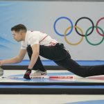 
              John Morris, of Canada, throws a rock during the mixed doubles curling match against Britain at the Beijing Winter Olympics Thursday, Feb. 3, 2022, in Beijing. (AP Photo/Brynn Anderson)
            