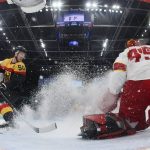 
              Germany's Patrick Hager (50) sprays snow as he stops near China goalkeeper Jieruimi Shimisi (Jeremy Smith) (45) during a preliminary round men's hockey game at the 2022 Winter Olympics, Saturday, Feb. 12, 2022, in Beijing. (Bruce Bennett/Pool Photo via AP)
            
