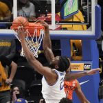 
              Pittsburgh's John Hugley (23) misses a dunk as Virginia Tech's David N'Guessan (1) defends during the second half of an NCAA college basketball game, Saturday, Feb. 5, 2022, in Pittsburgh. (AP Photo/Keith Srakocic)
            