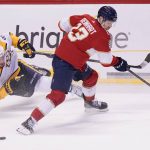 
              Florida Panthers center Sam Reinhart (13) and Nashville Predators center Ryan Johansen (92) battle for the puck during the second period of an NHL hockey game, Tuesday, Feb. 22, 2022, in Sunrise, Fla. (AP Photo/Wilfredo Lee)
            