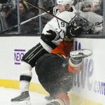 
              Los Angeles Kings' Carl Grundstrom, top, collides with Anaheim Ducks' Isac Lundestrom during the first period of an NHL hockey game Friday, Feb. 25, 2022, in Anaheim, Calif. (AP Photo/Jae C. Hong)
            