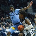 
              Butler's Chuck Harris (3) goes to the basket against Marquette's Kam Jones (1) during the first half of an NCAA college basketball game, Saturday, Feb. 12, 2022, in Indianapolis. (AP Photo/Darron Cummings)
            