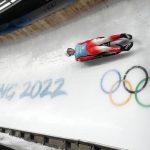 
              Mateusz Sochowicz of Poland speeds past the Olympic rings during a men's luge training run at the 2022 Winter Olympics, Wednesday, Feb. 2, 2022, in the Yanqing district of Beijing. (AP Photo/Mark Schiefelbein)
            