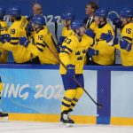 
              Sweden's Lucas Wallmark (23) celebrates his goal with teammates against Slovakia during a preliminary round men's hockey game at the 2022 Winter Olympics, Friday, Feb. 11, 2022, in Beijing. (AP Photo/Petr David Josek)
            