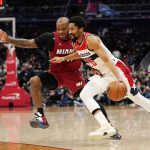 
              Miami Heat forward P.J. Tucker, left, defends Washington Wizards guard Spencer Dinwiddie during the first half of an NBA basketball game, Monday, Feb. 7, 2022, in Washington. (AP Photo/Evan Vucci)
            