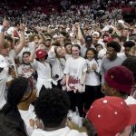 
              Arkansas fans storm the court after to celebrate after their school's win over No. 1 Auburn 80-76 in overtime in an NCAA college basketball game Tuesday, Feb. 8, 2022, in Fayetteville, Ark. (AP Photo/Michael Woods)
            