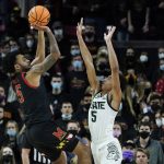 
              Maryland guard Eric Ayala, left, shoots against Michigan State guard Max Christie during the first half of an NCAA college basketball game, Tuesday, Feb. 1, 2022, in College Park, Md. (AP Photo/Julio Cortez)
            