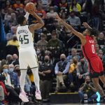 
              Utah Jazz guard Donovan Mitchell (45) shoots as Houston Rockets guard Jalen Green (0) defends in the first half during an NBA basketball game Monday, Feb. 14, 2022, in Salt Lake City. (AP Photo/Rick Bowmer)
            