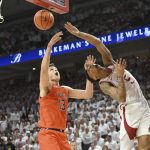 
              Arkansas guard Au'Diese Toney (5) has his shot blocked by Auburn forward Walker Kessler (13) as he drives to the hoop during the first half of an NCAA college basketball game Tuesday, Feb. 8, 2022, in Fayetteville, Ark. (AP Photo/Michael Woods)
            