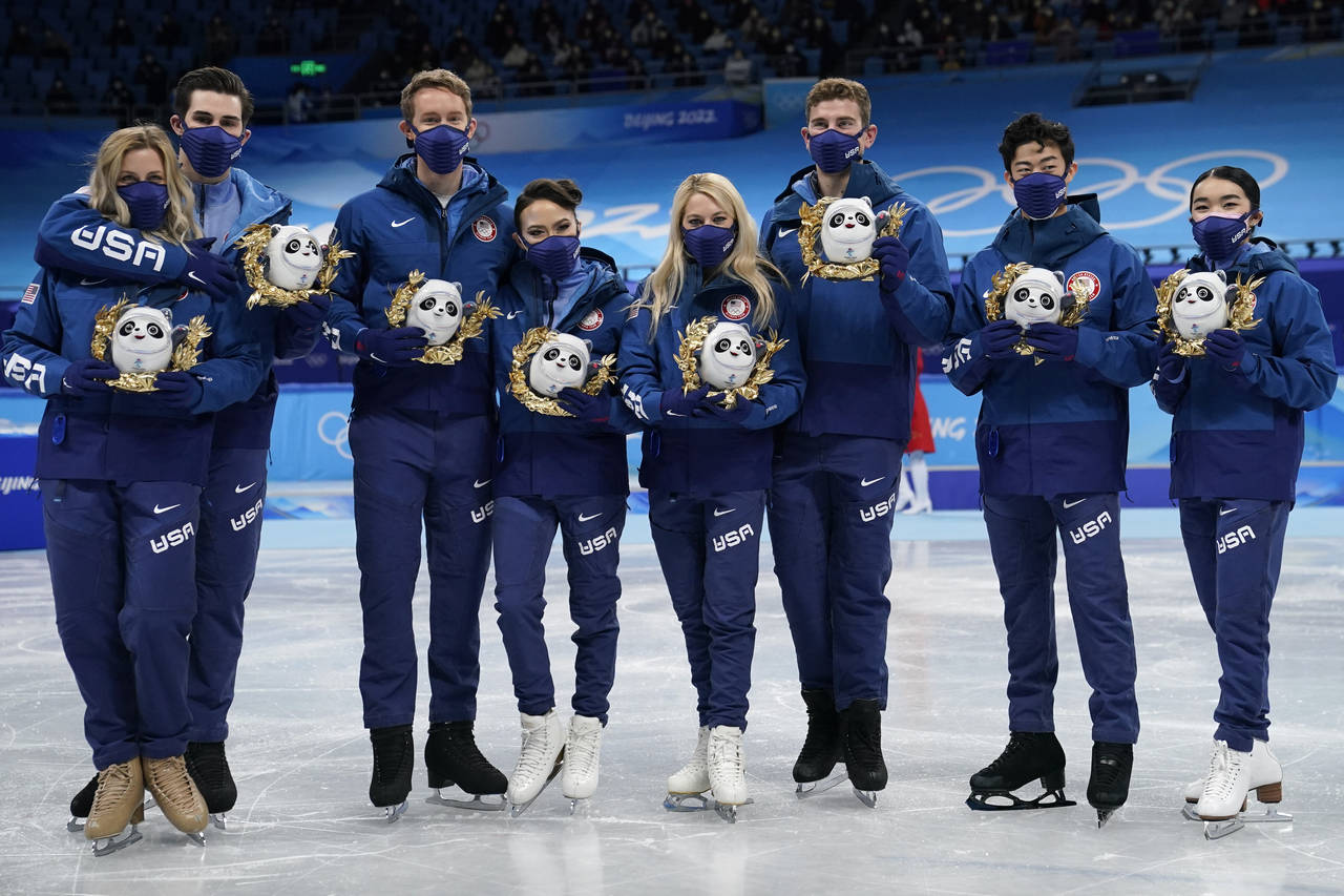 Silver medalists Team United States stand pose for a group photo following the victory ceremony aft...