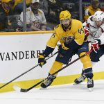 
              Nashville Predators defenseman Alexandre Carrier (45) moves the puck next to Washington Capitals right wing Daniel Sprong (10) during the first period of an NHL hockey game Tuesday, Feb. 15, 2022, in Nashville, Tenn. (AP Photo/Mark Zaleski)
            