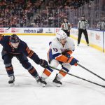 
              New York Islanders' Mathew Barzal (13) is chased by Edmonton Oilers' Tyson Barrie (22) during the first period of an NHL hockey game Friday, Feb. 11, 2022, in Edmonton, Alberta. (Jason Franson/The Canadian Press via AP)
            