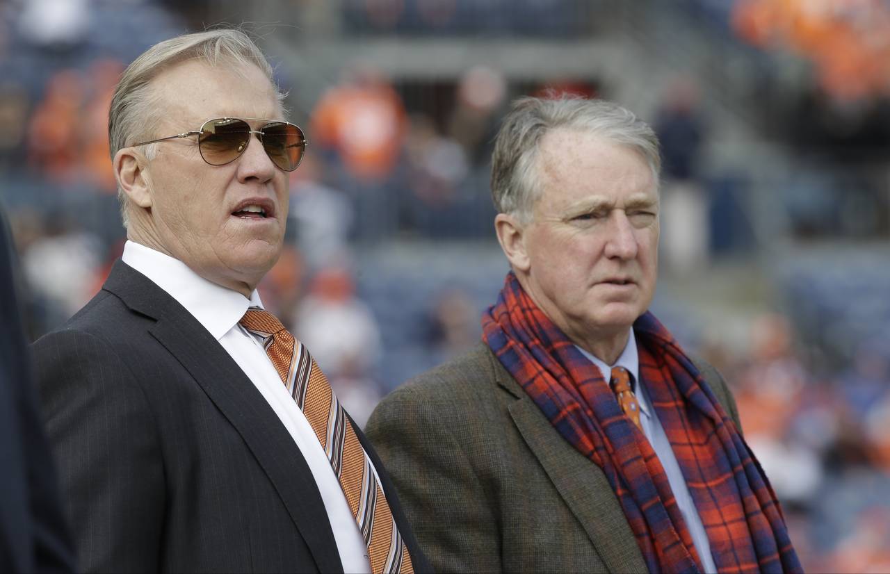 FILE - Denver Broncos general manager John Elway, left, stands with Broncos President and CEO Joe E...