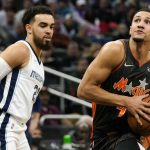 
              Orlando Magic guard Jalen Suggs, right, drives past Memphis Grizzlies guard Tyus Jones, left, on his way to the basket during the first half of an NBA basketball game, Saturday, Feb. 5, 2022, in Orlando, Fla. (AP Photo/John Raoux)
            