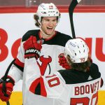
              New Jersey Devils' Dawson Mercer (18) celebrates with teammate Jesper Boqvist after scoring against the Montreal Canadiens during the first period of an NHL hockey game in Montreal, Tuesday, Feb., 8, 2022. (Graham Hughes/The Canadian Press via AP)
            