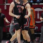 
              Utah's Riley Battin (11) celebrates with Lazar Stefanovic after scoring against Oregon State during the second half during an NCAA college basketball game Thursday, Feb. 3, 2022, in Salt Lake City. (AP Photo/Rick Bowmer)
            