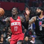 
              Houston Rockets guard Dennis Schroder, left shoots as Los Angeles Clippers forward Marcus Morris Sr. defends during the first half of an NBA basketball game Thursday, Feb. 17, 2022, in Los Angeles. (AP Photo/Mark J. Terrill)
            