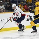 
              Washington Capitals defenseman Dmitry Orlov (9) gets control of the puck in front of Nashville Predators center Colton Sissons (10) during the second period of an NHL hockey game Tuesday, Feb. 15, 2022, in Nashville, Tenn. (AP Photo/Mark Zaleski)
            