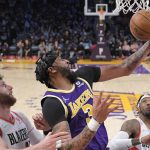 
              Los Angeles Lakers forward Anthony Davis, second from left, grabs a rebound as Portland Trail Blazers center Jusuf Nurkicm, left, defends during the second half of an NBA basketball game Wednesday, Feb. 2, 2022, in Los Angeles. (AP Photo/Mark J. Terrill)
            