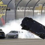
              Harrison Burton, right, flips as he wrecks on the backstretch as Christopher Bell, left, and Ross Chastain try but are unable to avoid the crash during the NASCAR Daytona 500 auto race at Daytona International Speedway, Sunday, Feb. 20, 2022, in Daytona Beach, Fla. (AP Photo/Chuck McQuinn)
            