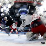 
              United States' Savannah Harmon (15) scores a goal against Russian Olympic Committee goalkeeper Maria Sorokina, right, during a preliminary round women's hockey game at the 2022 Winter Olympics, Saturday, Feb. 5, 2022, in Beijing. (Song Yanhua/Pool Photo via AP)
            