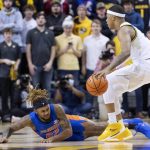 
              Florida's Brandon McKissic, left, falls to the court in front of Missouri's Jarron Coleman, right, after McKissic was fouled during the first half of an NCAA college basketball game Wednesday, Feb. 2, 2022, in Columbia, Mo. (AP Photo/L.G. Patterson)
            