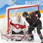 
              Canada forward Natalie Spooner (24) is stopped by Switzerland goalkeeper Andrea Braendli (20) during the first period of a women's hockey game Thursday, Feb. 3, 2022, at the Winter Olympics in Beijing. (Ryan Remiorz/The Canadian Press via AP)
            