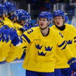 
              Sweden's Lucas Wallmark (23) is congratulated after scoring a goal against Latvia during a preliminary round men's hockey game at the 2022 Winter Olympics, Thursday, Feb. 10, 2022, in Beijing. (AP Photo/Matt Slocum)
            