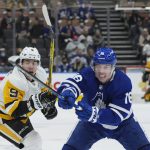 
              Toronto Maple Leafs forward Mitchell Marner (16) and Pittsburgh Penguins forward Evan Rodrigues (9) vie for the puck during the third period of an NHL hockey game Thursday, Feb. 17, 2022, in Toronto. (Nathan Denette/The Canadian Press via AP)
            