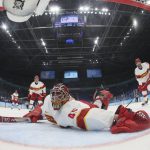 
              China goalkeeper Jieruimi Shimisi (Jeremy Smith) (45) reaches for the puck after United States' Brian Oneill scored a goal during a preliminary round men's hockey game at the 2022 Winter Olympics, Thursday, Feb. 10, 2022, in Beijing. (Bruce Bennett/Pool Photo via AP)
            