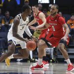 
              West Virginia forward Gabe Osabuohien (3) is defended by Texas Tech forward Kevin Obanor (0) during the first half of an NCAA college basketball game in Morgantown, W.Va., Saturday, Feb. 5, 2022. (AP Photo/Kathleen Batten)
            