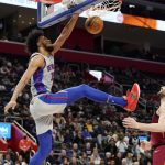 
              Detroit Pistons forward Marvin Bagley III (35) dunks as Cleveland Cavaliers forward Kevin Love defends during the first half of an NBA basketball game, Thursday, Feb. 24, 2022, in Detroit. (AP Photo/Carlos Osorio)
            