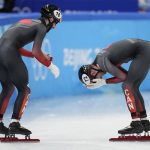 
              Steven Dubois, left, of team Canada, and teammate Pascal Dion celebrate after winning the men's 5000-meters relay final during the short track speedskating competition at the 2022 Winter Olympics, Wednesday, Feb. 16, 2022, in Beijing. (AP Photo/Natacha Pisarenko)
            