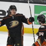 
              Anaheim Ducks left wing Rickard Rakell (67) is congratulated by Jamie Drysdale (34) after scoring a goal during the second period against the San Jose Sharks in an NHL hockey game Tuesday, Feb. 22, 2022, in Anaheim, Calif. (AP Photo/John McCoy)
            