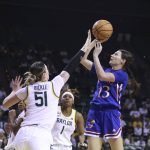 
              Kansas guard Holly Kersgieter, right, attempts a shot over Baylor forward Caitlin Bickle, left, in the first half of an NCAA college basketball game, Saturday, Feb. 26, 2022, in Waco, Texas. (AP Photo/Rod Aydelotte)
            