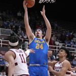 
              UCLA guard Jaime Jaquez Jr. (24) drives to the basket between Stanford's Jaiden Delaire (11) and Spencer Jones, right, during the second half of an NCAA college basketball game in Stanford, Calif., Tuesday, Feb. 8, 2022. (AP Photo/Tony Avelar)
            
