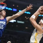 
              Golden State Warriors guard Klay Thompson, right, shoots as Los Angeles Clippers center Isaiah Hartenstein defends during the first half of an NBA basketball game Monday, Feb. 14, 2022, in Los Angeles. (AP Photo/Mark J. Terrill)
            