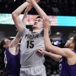
              Purdue center Zach Edey, center, goes up for a shot against Northwestern forward Robbie Beran, left, and forward Pete Nance during the first half of an NCAA college basketball game in Evanston, Ill., Wednesday, Feb. 16, 2022. (AP Photo/Nam Y. Huh)
            
