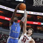 
              North Carolina guard Leaky Black (1) grabs a rebound away from Louisville forward Matt Cross (33) during the second half of an NCAA college basketball game in Louisville, Ky., Tuesday, Feb. 1, 2022. North Carolina won 90-83. (AP Photo/Timothy D. Easley)
            