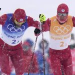 
              Sergey Ustiugov, of the Russian Olympic Committee, left, and Denis Spitsov, of the Russian Olympic Committee, compete during the men's 4 x 10km relay cross-country skiing competition at the 2022 Winter Olympics, Sunday, Feb. 13, 2022, in Zhangjiakou, China. (AP Photo/Alessandra Tarantino)
            